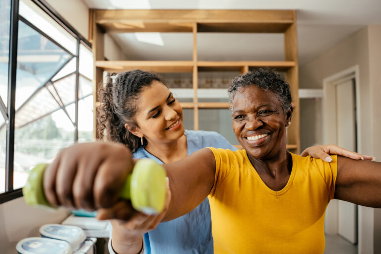 Elderly woman doing physical therapy with dumbbells