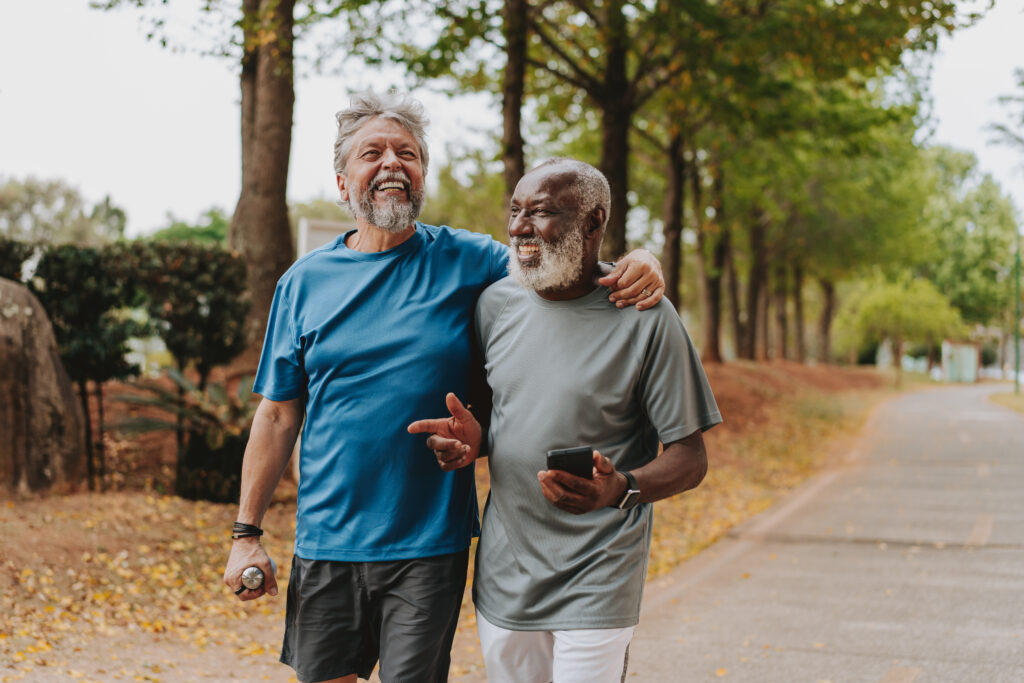 Two senior friends running in the public park