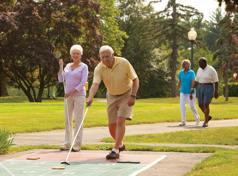 Seniors playing shuffleboard together outside