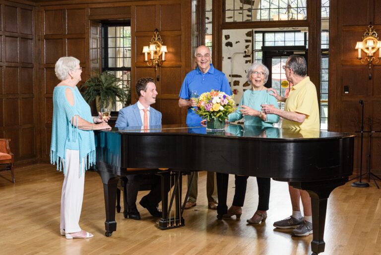 seniors around a piano