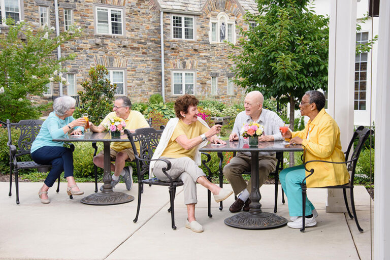 seniors sitting outside drinking wine