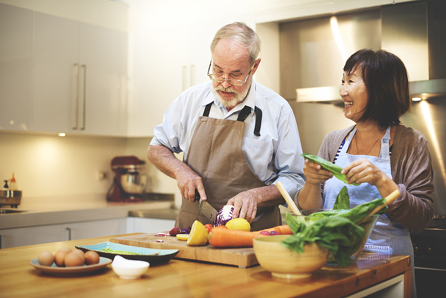 An older couple cooks family recipes in their kitchen