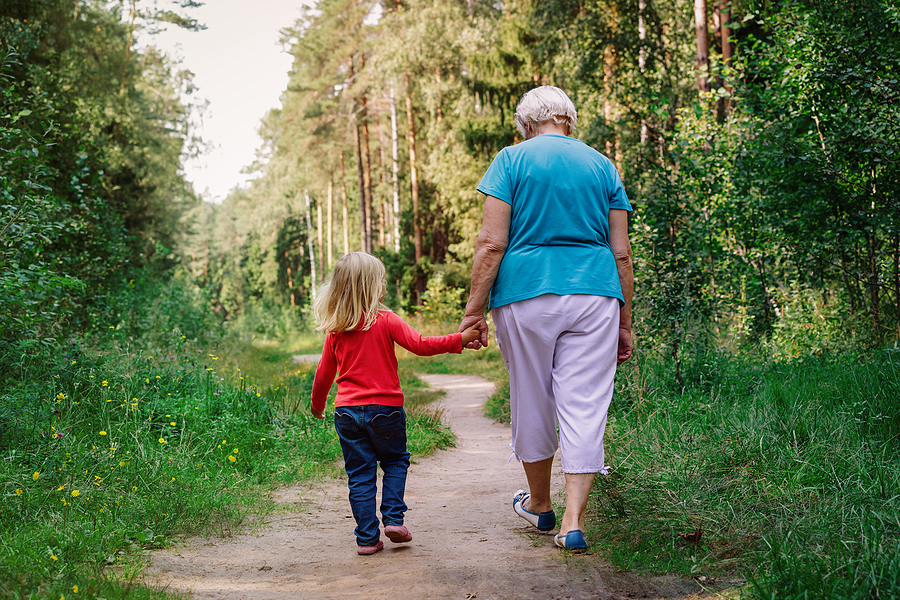 grandmother with granddaughter walk in nature, active seniors
