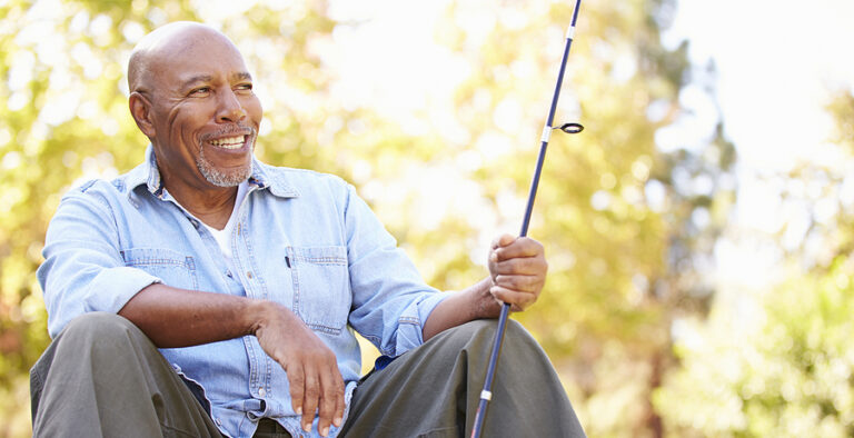 Senior Man On Camping Holiday With Fishing Rod