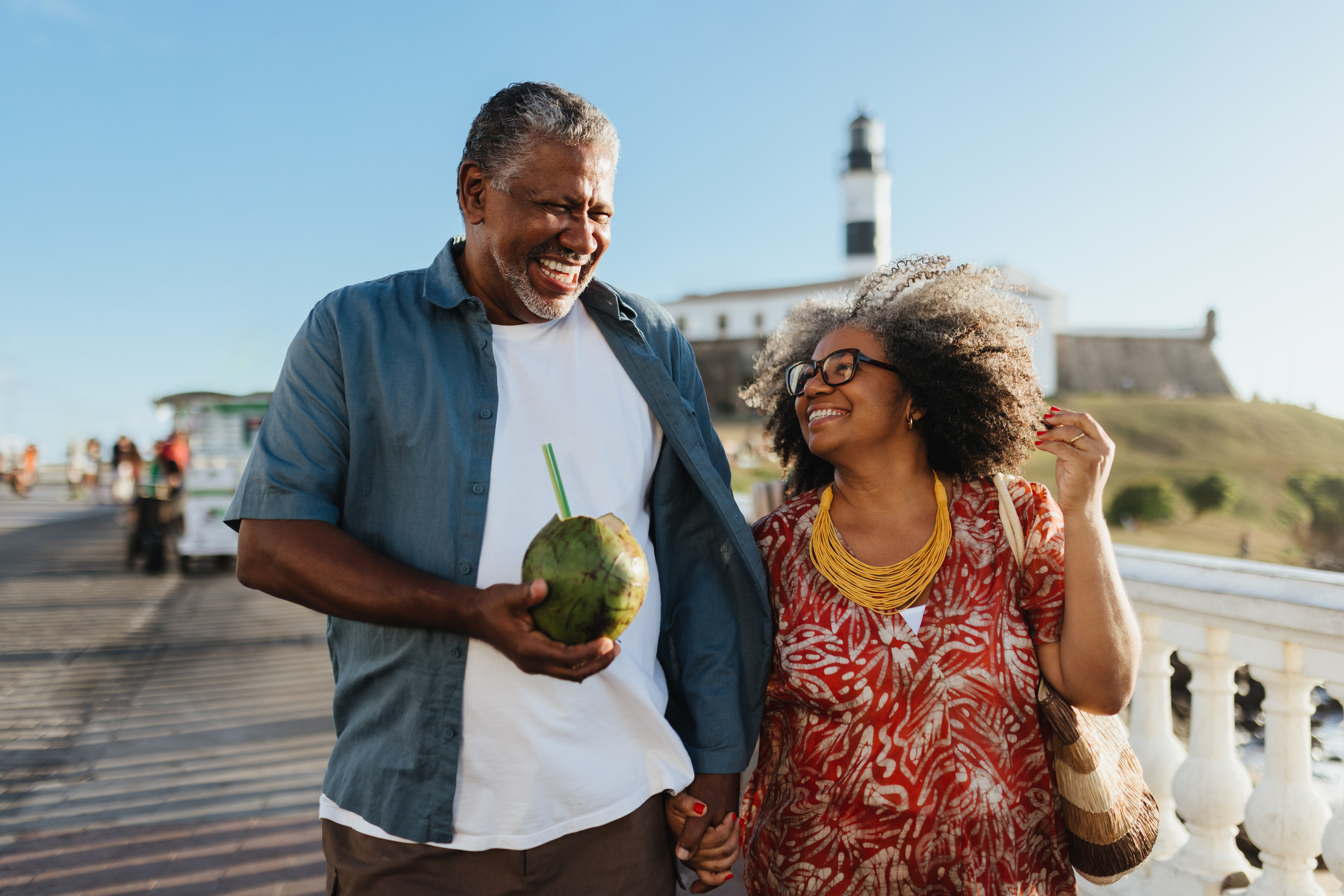 An older couple enjoys vacation with a coconut drink